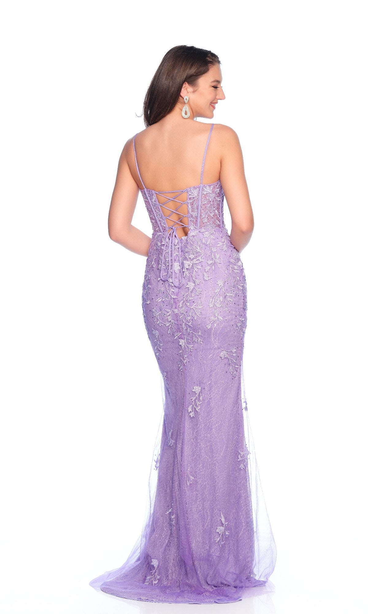A woman wearing the Dave & Johnny 12315 Lilac Purple Prom Dress, featuring spaghetti straps, a lace-up corset bodice, and a high-leg slit, stands facing away from the camera.